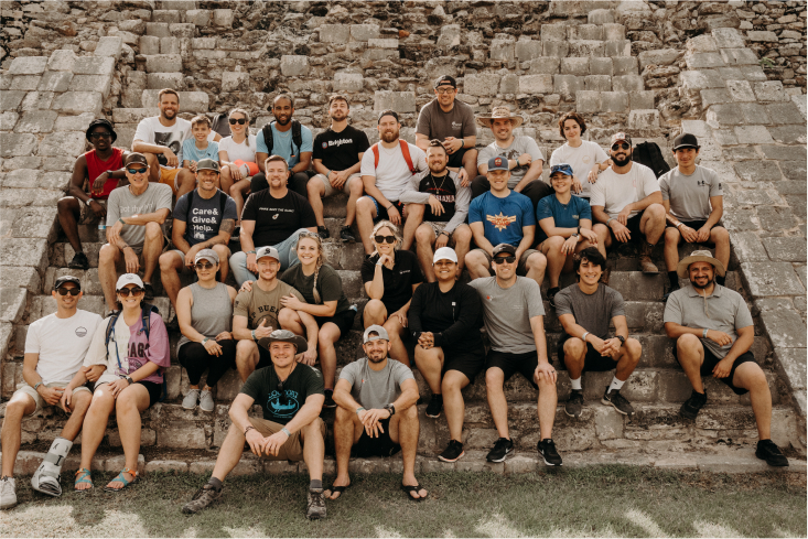 A group of reps sitting at the steps of a mesoamerican pyramid
