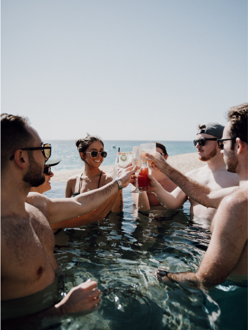 A small group of reps enjoying drinks in a shallow pool of water