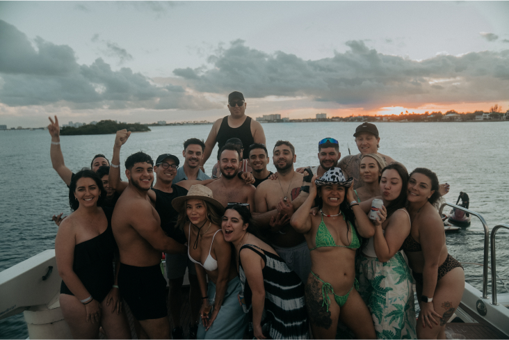 A group of reps on a boat during a sunset